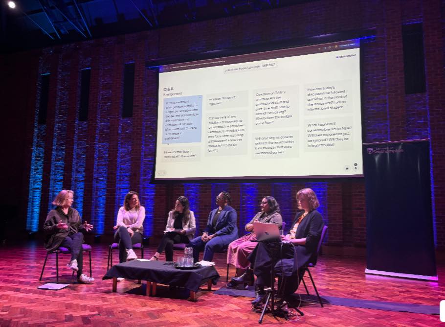 Caroline and panel members speaking on stage as part of a Q&A session at the University of Southampton