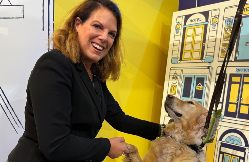 Caroline with an assistance dog at the Guide Dogs UK stand during Conservative Party Conference in Birmingham